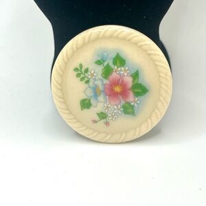This is a sweet Avon porcelain-style floral brooch (70s-80s vibe).